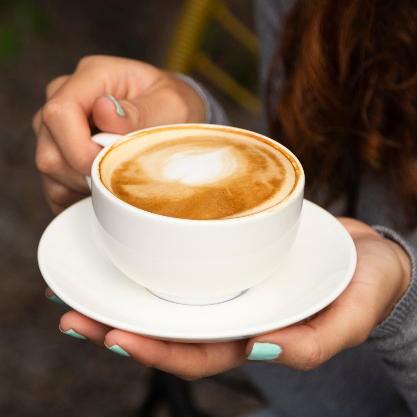 close-up-woman-holding-coffee-cup